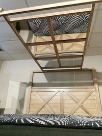 The Vaughan Bassett Cool Rustic King Mirrored Canopy Bed has a solid oak frame; its mirror tops reflect the bed and tiles.