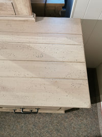 Rustic charm: Vaughan Bassett's 176 Cool Rustic Dresser, wooden tabletop, black handles on textured carpet.