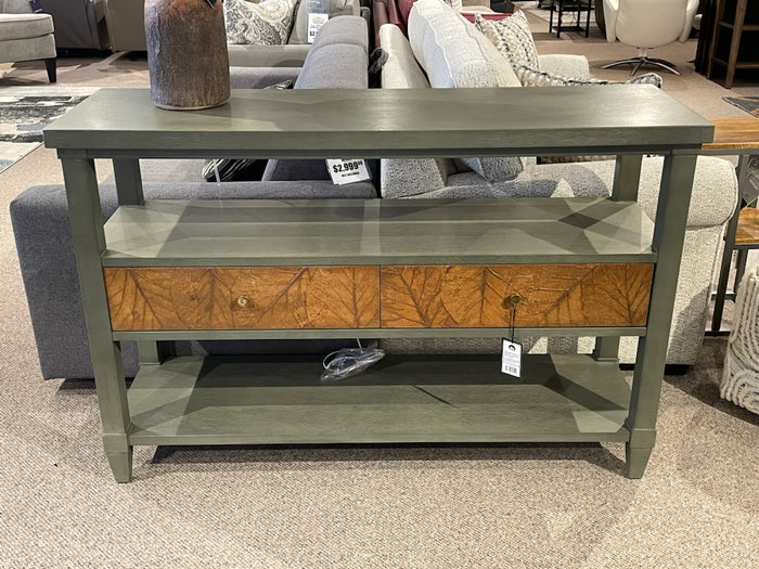 The Crestview Collection Arbor Two-Door Console Table features sage green finish, wood drawers, and a lower shelf.