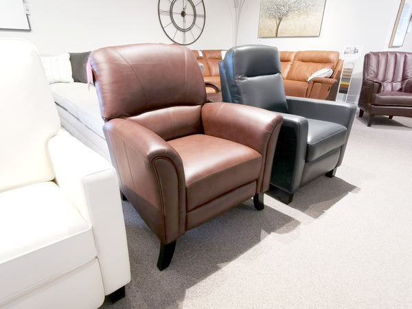A Leather Craft 698 Reclining Chair sits in a showroom with black, white, and brown Canadian leather sofas and chairs.