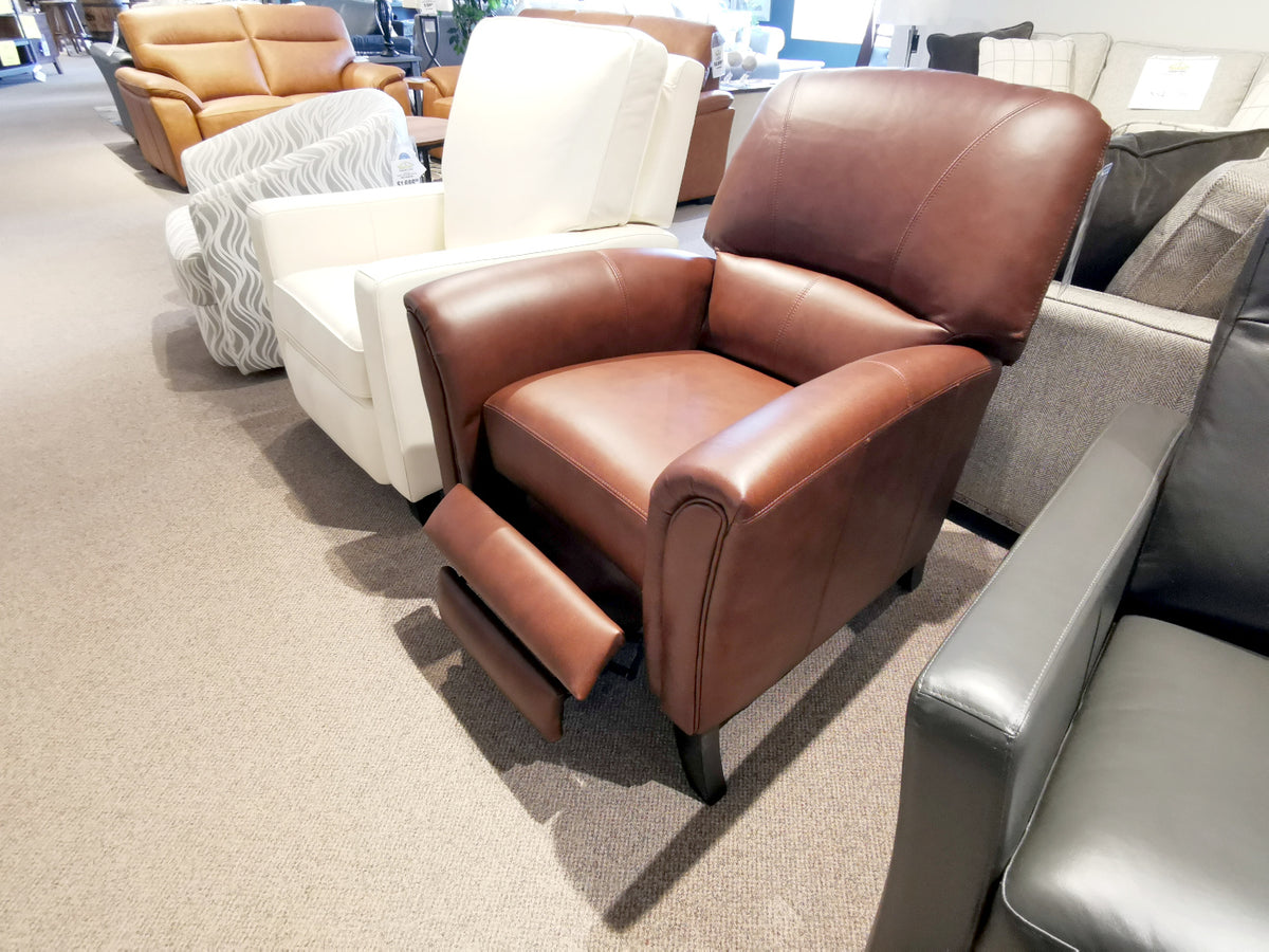 A Leather Craft 698 Reclining Chair with extended footrest is displayed in a furniture showroom.