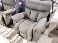 La-Z-Boy's 775 Mateo Rocker Recliner with padded armrests displayed on a patterned rug in-store.