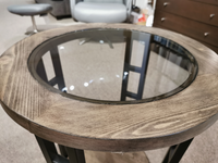 9021-06 Round End Table by Null Furniture: Cedar veneer with glass top, in a room with additional furniture.