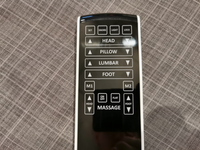 The Fashion Prodigy Comfort Elite remote controls head, pillow, lumbar, foot, and massage on grey fabric.