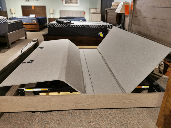Fashion Prodigy Comfort Elite Adjustable Bed with Wallhugger tech on display among beds and bedroom furniture.