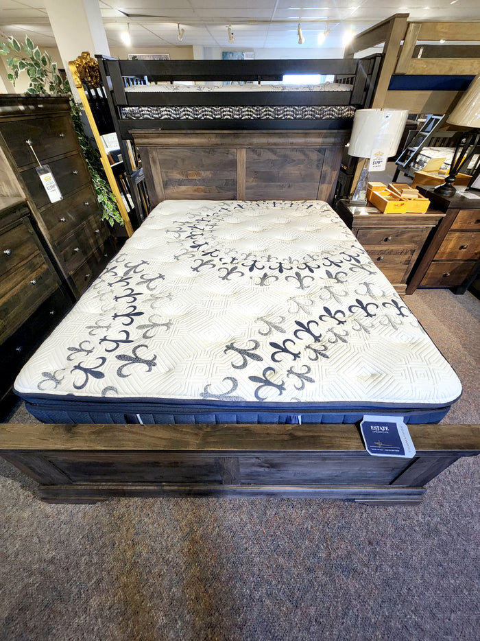 Room with a wooden bunk bed and a Stearns & Foster Mon Cheri mattress with floral patterns, surrounded by storage pieces.