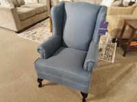 The Q30 Wing Back Chair by Superstyle features blue upholstery, dark wood legs, and classic traditional style.