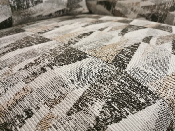 Close-up of the Superstyle 312 Swivel Chair's fabric, featuring a geometric pattern in shades of gray, beige, and black, ideal for upholstering a compact accent chair that adds an elegant touch to any room.