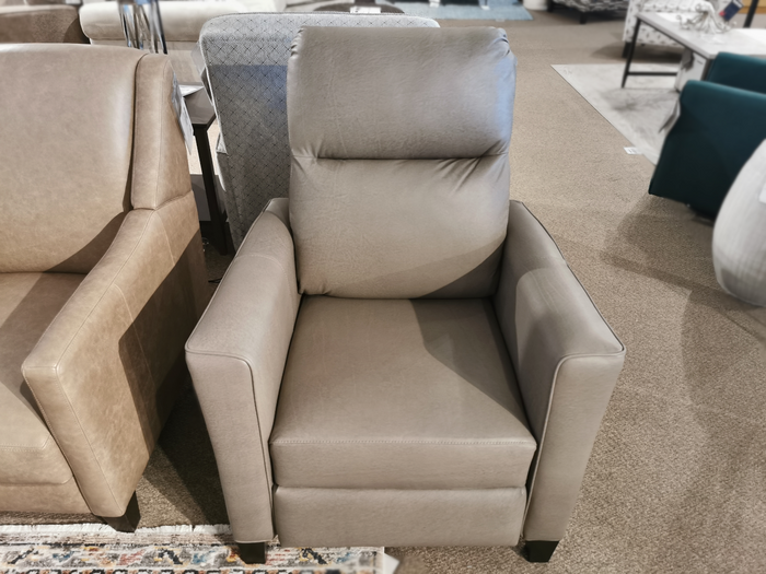 Superstyle L35 Push Back Recliner in gray, features a high back and cushioned armrests on a carpeted showroom floor.