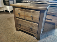 The Vaughan Bassett 801 Cool Farmhouse nightstand features custom pewter pulls in a cozy room setting.