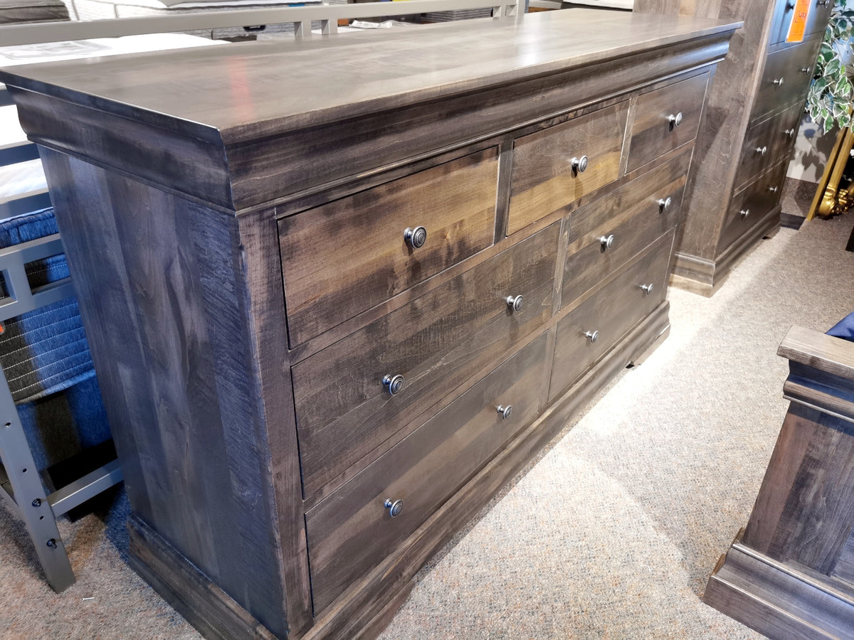 The Vokes 462 Bayshore 7-Drawer Dresser features metal knobs and is displayed on a carpeted floor.