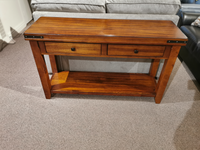 Mango Sofa Table by Winners Only: classic wood with 2 drawers on beige carpet, next to a gray sofa.