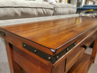 Winners Only's Mango Sofa Table with metal accents complements the light gray sofa.