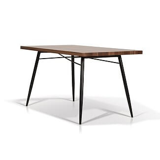 Korson Jaffe Dining Table: rectangular wooden table with splayed legs and a smooth, flat surface.