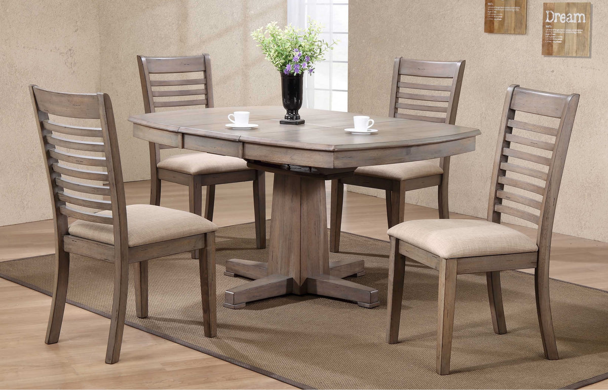 The Ventura Pedestal Table by Winners Only with four chairs, vase, and cups sits on a Santa Fe brown rug.