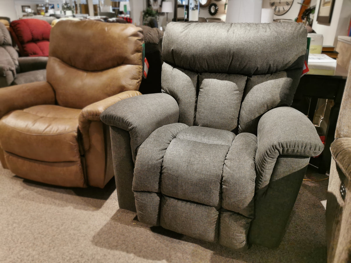 The showroom features two La-z-boy recliners: the 775 Mateo Rocker Recliner in gray and a brown one, both with adjustable legrests.