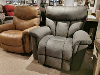 The showroom features two La-z-boy recliners: the 775 Mateo Rocker Recliner in gray and a brown one, both with adjustable legrests.