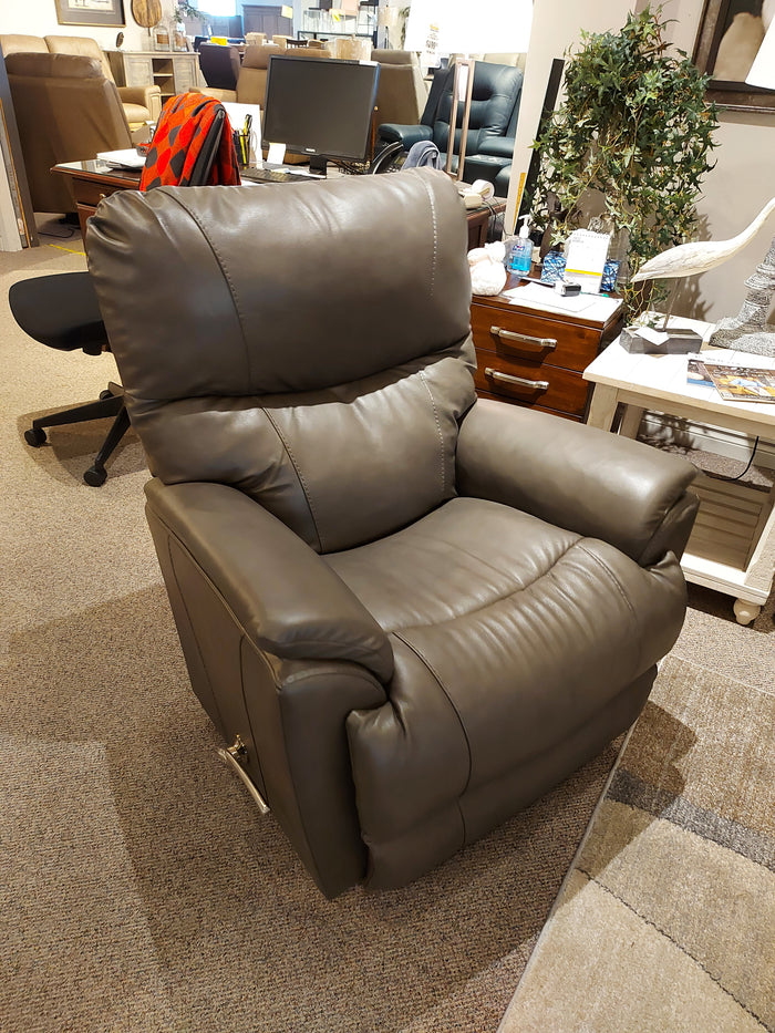 The La-z-boy 724 Trouper Leather Recliner, dark gray with lumbar support, is displayed on a showroom carpet.