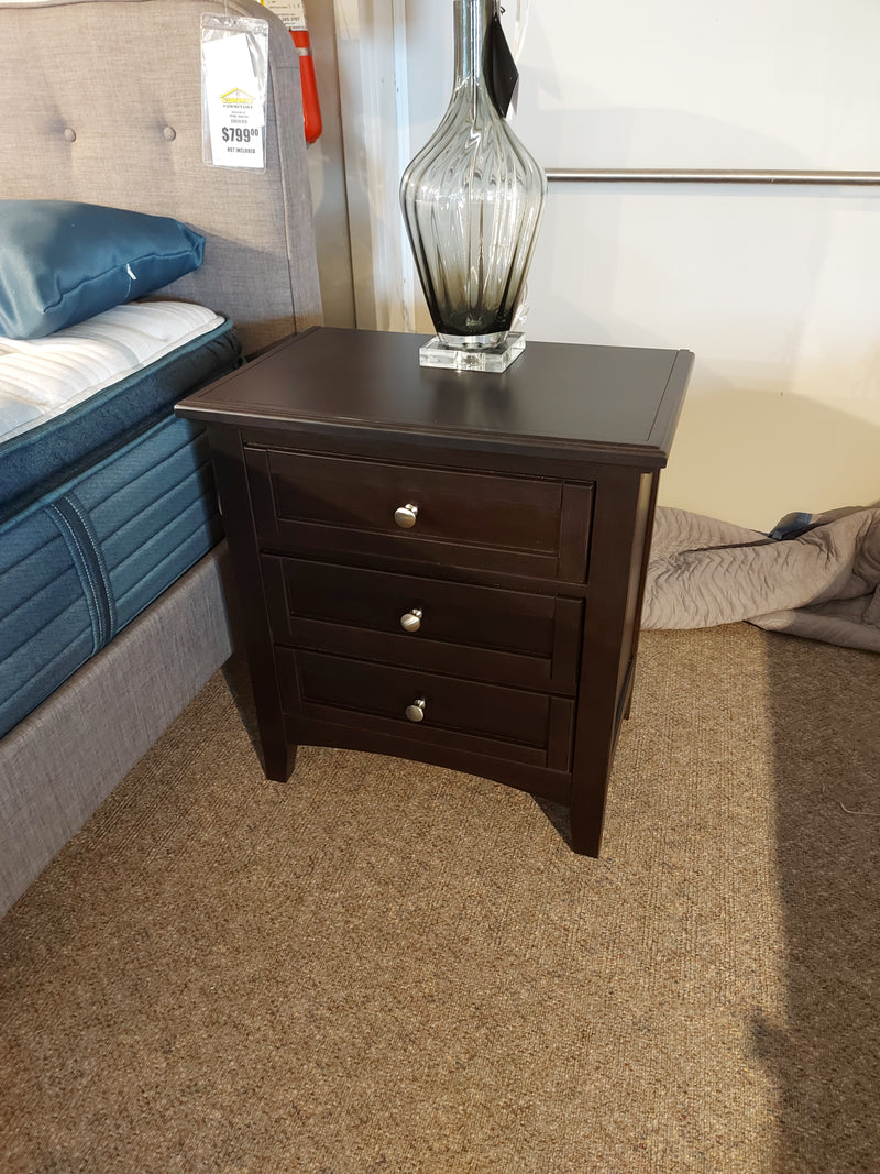 Vaughan Bassett BB27 Merlot Night stand with cherry veneers, 3 drawers, silver knobs, and a decorative vase beside the bed.