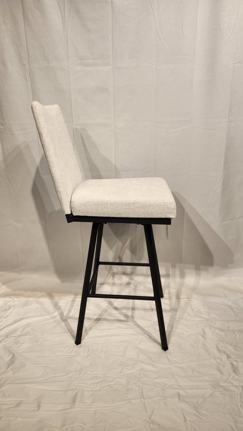 Side view of Linea Swivel Bar Stool by Amisco with light gray cushion and black metal frame on a white background.