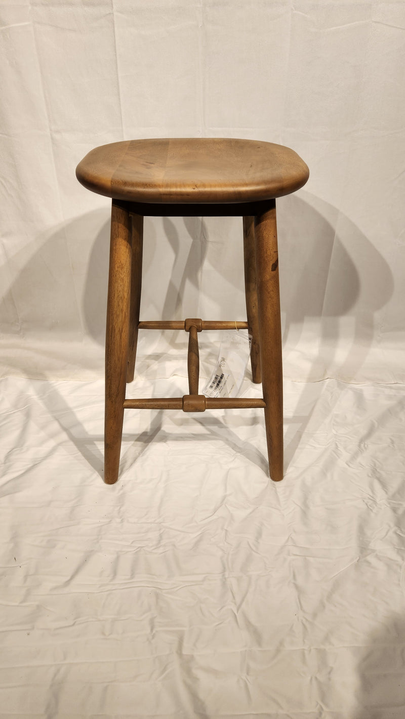 The Ernest Counter Height Bar Stool by Mercana, with four legs and a round seat, sits on a white surface and backdrop.
