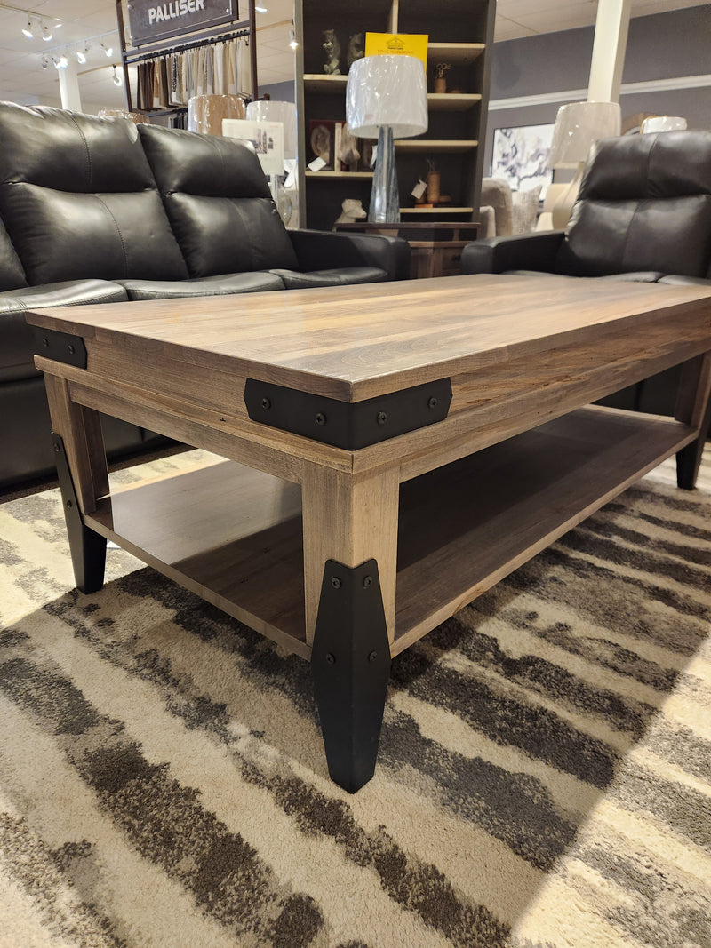 Handstone N-CH2854X Chattanooga Coffee Table with classic design sits on a rug between black recliners in the showroom.