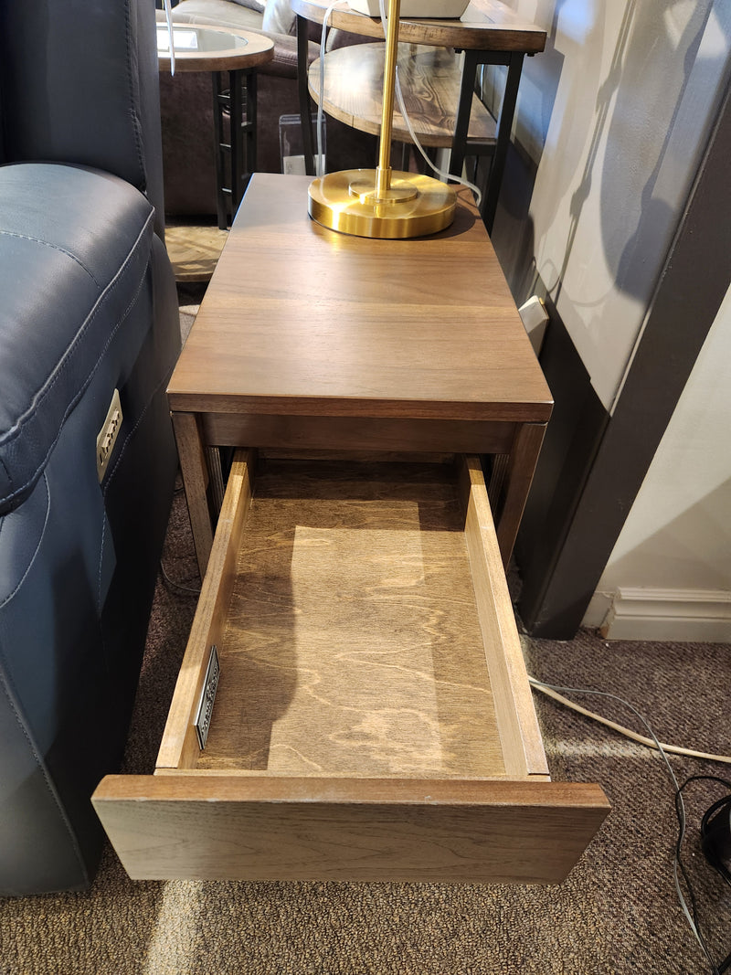 A Handstone N-EV23 Evora Chairside End Table sits by a blue sofa, topped with a brass lamp.