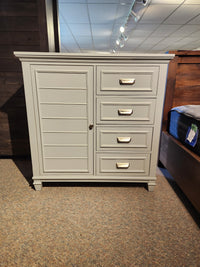 B5611 Charleston Chest by Magnussen: Gray, left-door plus 4-drawer cabinet, ideal for a lit transitional showroom with carpet.