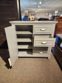 The Magnussen B5611 Charleston Chest offers gray shelves and drawers, ideal for a modern farmhouse style.