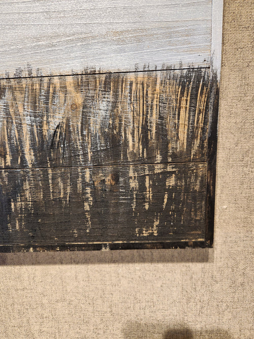 Close-up of Mercana's "67722 Holstein," a textured painting featuring abstract dark vertical lines set against a two-tone background, beautifully framed in wood, making it ideal for rustic home decor.