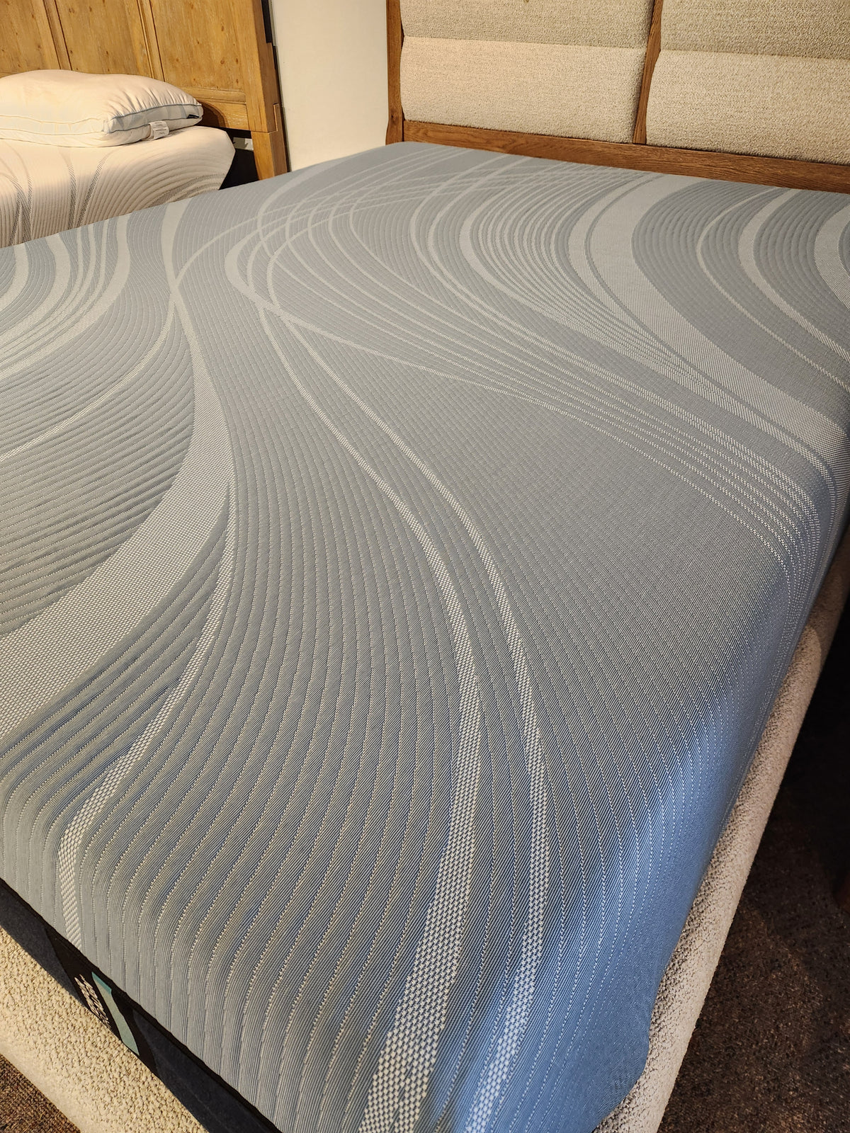 A furnished bedroom with a Pro Align 2.0 - Firm by Tempur-pedic, featuring advanced pressure relief and blue cover.
