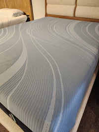 A furnished bedroom with a Pro Align 2.0 - Firm by Tempur-pedic, featuring advanced pressure relief and blue cover.