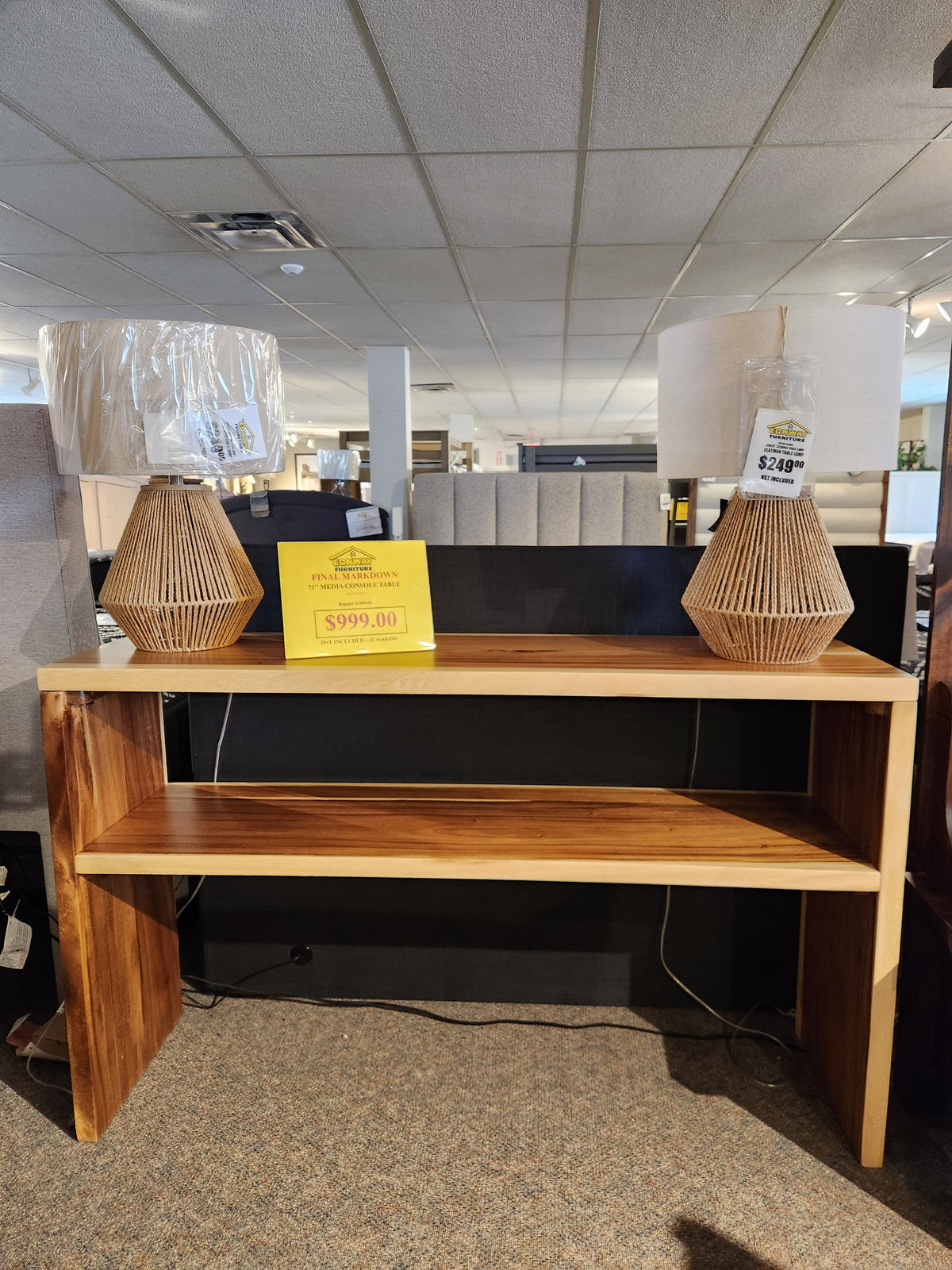 Heft's 71" Media Console Table, ideal for your entertainment space, topped with two wicker lamps, costs $999.00.