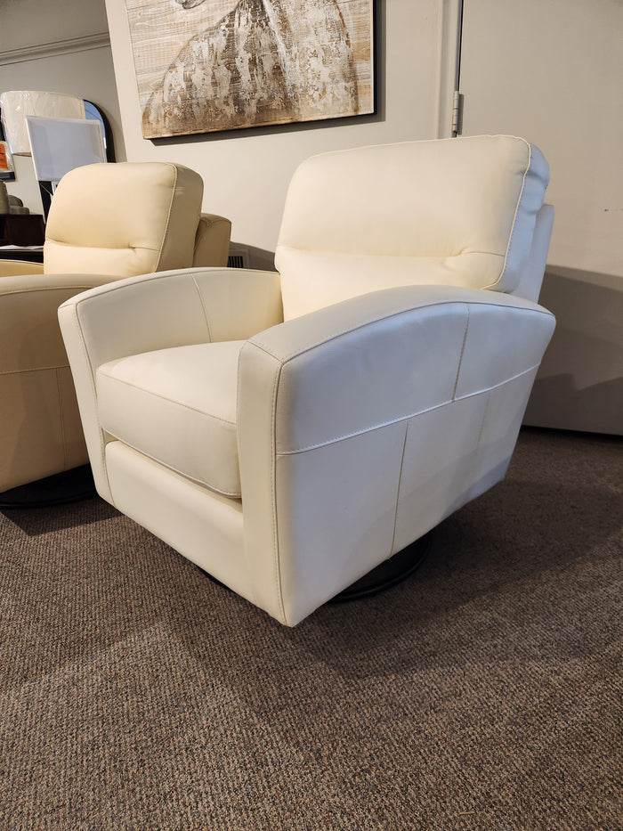 The cream Leather Craft 744B Leather Swivel Chair, with a carpeted base, is next to similar furniture and wall art.
