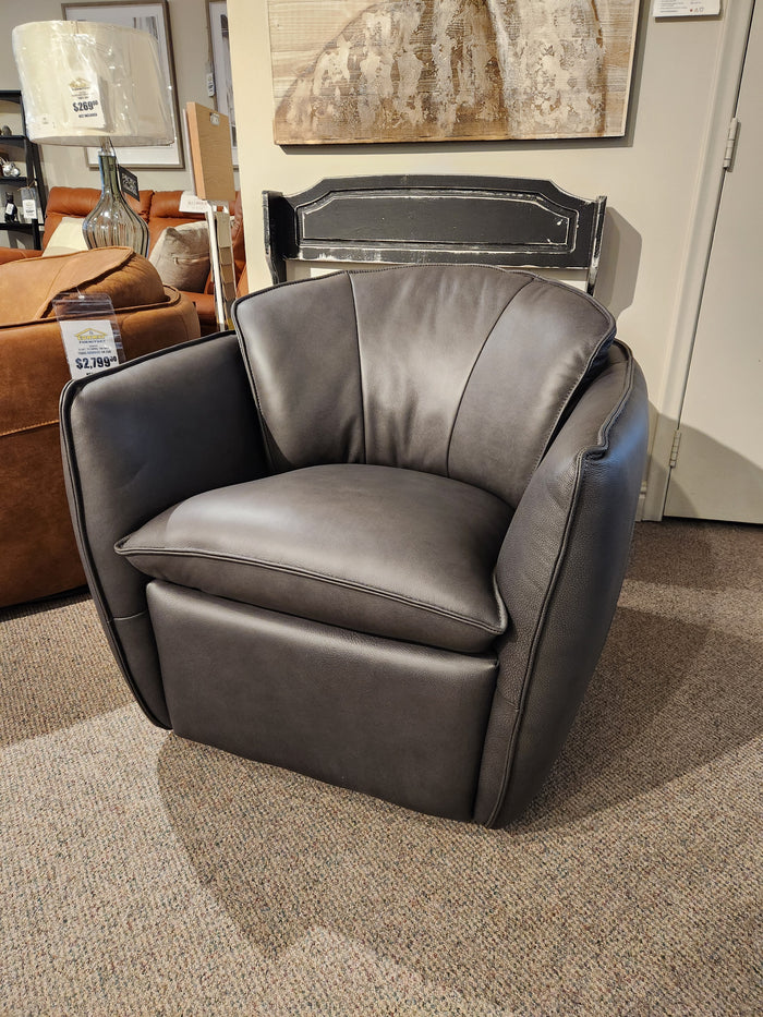 A modern dark gray 752 Swivel Chair by Leather Craft with cushioned seating, featured in a Toronto handmade furniture showroom.