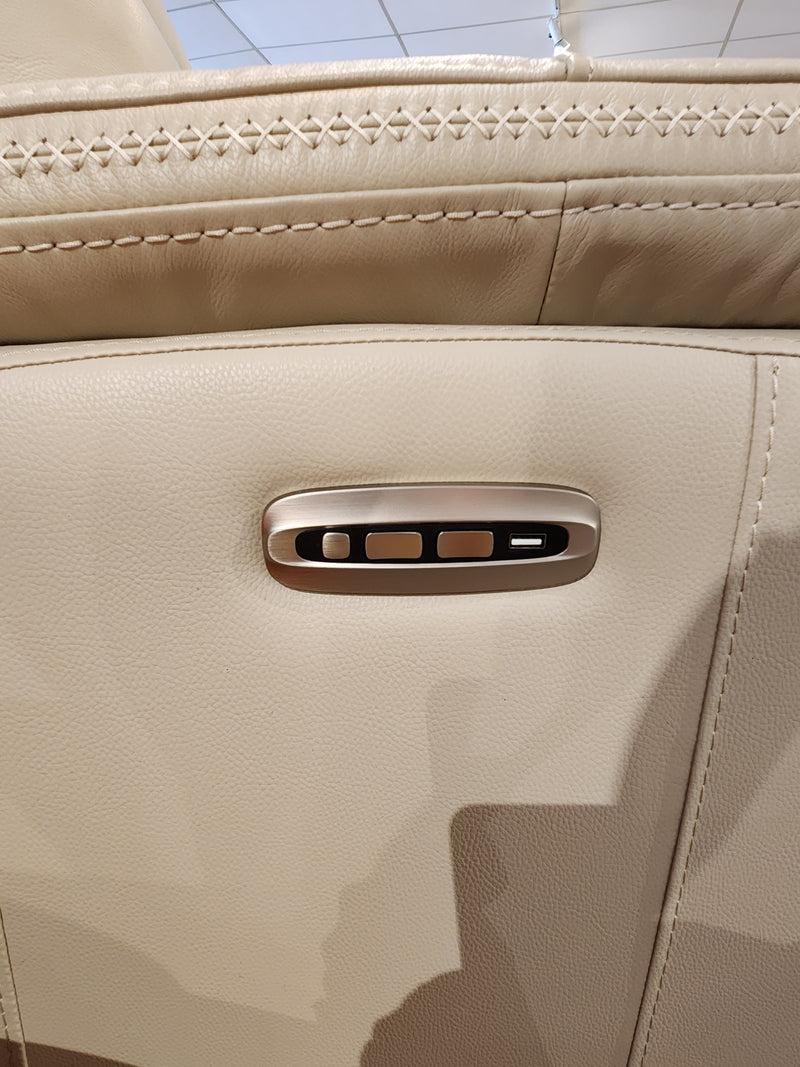 Close-up of beige Cascade Power Chair seat by Aurora Furniture with three metallic adjustment buttons and stitching detail.