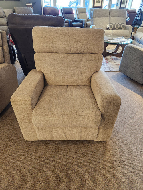 The Palliser 41049 Oakwood Manual Chair Wallhugger in beige is showcased on a carpeted showroom floor.