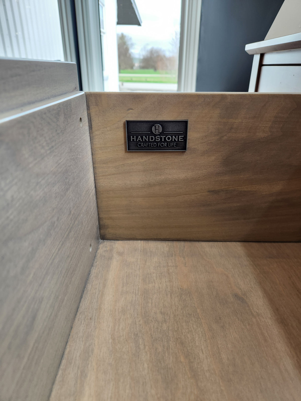 A close-up of the Brooklyn Dining Sideboard with Pot Lights by Handstone showcases contemporary wooden drawer details.