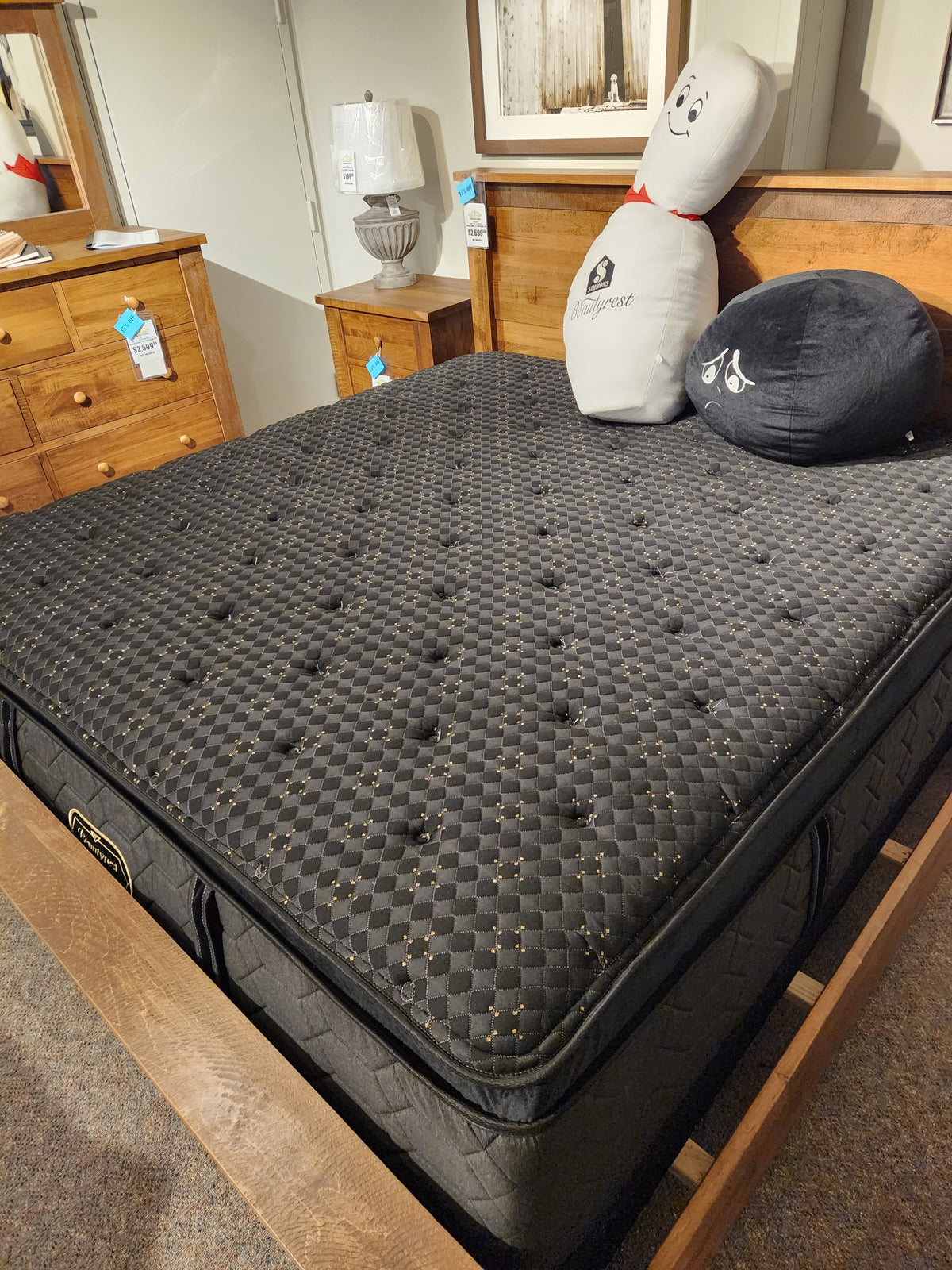 A Beauty-rest Hermes Ultra Plush Mattress with latex foam on a wooden frame, plus novelty pillows and furniture.