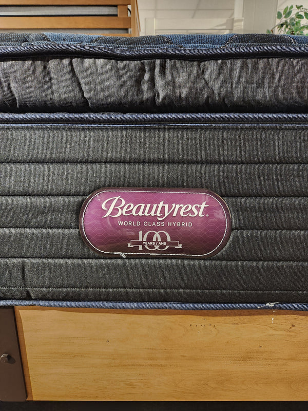 A Beauty-rest Lusso Plush SPT Mattress sits on a wooden bed frame.