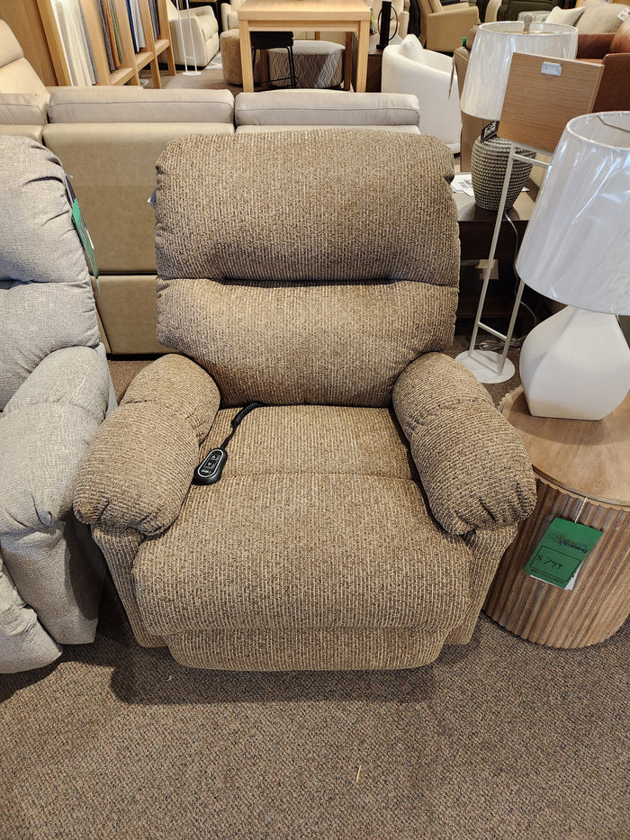 The Best 7MP84 Ellisport Power Space Saver Recliner with remote, in brown, is shown in a furniture showroom.
