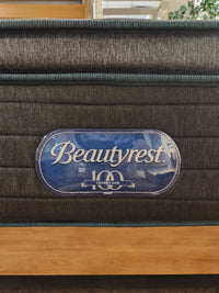 A Beauty-rest Eryx PT Medium Mattress featuring memory foam and a blue "10 Years Warranty" label on its side.
