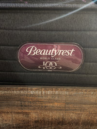 A Beauty-rest ESME TT Medium Mattress label is shown on a wooden bed frame, promising restful sleep nightly.