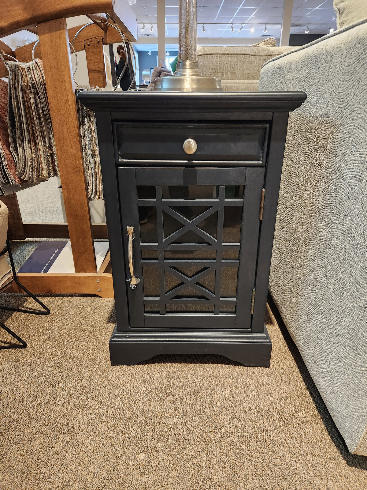 The Jofran Craftsman Power Chairside Table features a black wood finish, drawer, and glass door—expertly crafted.