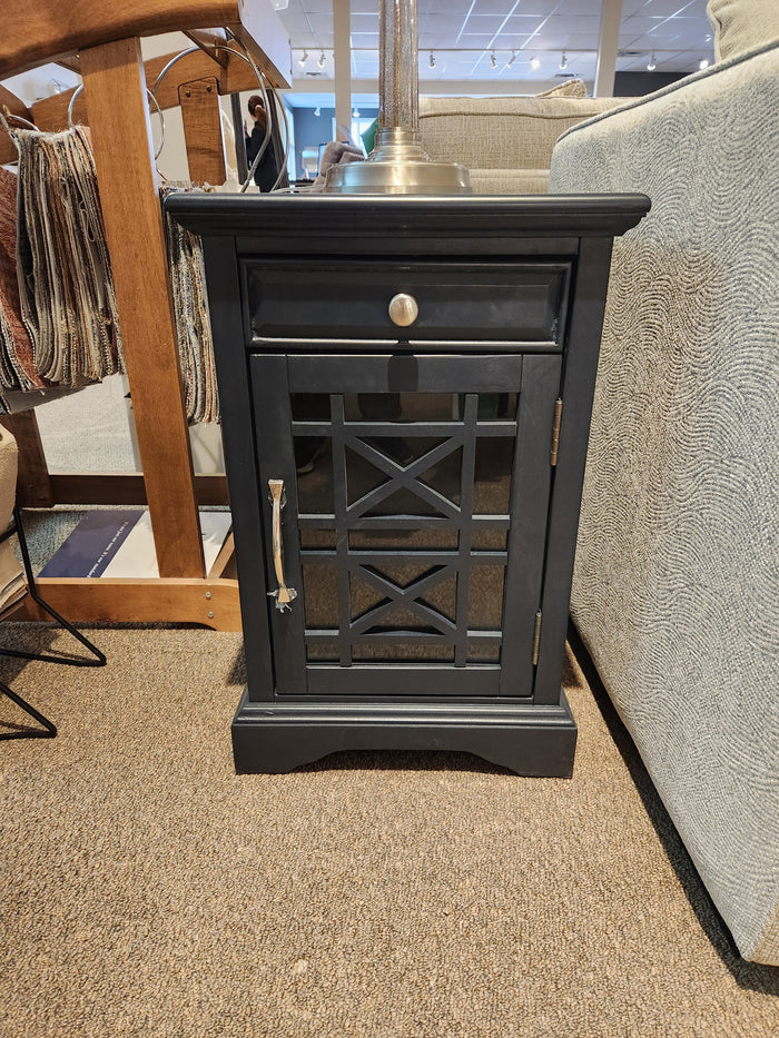 The Jofran Craftsman Power Chairside Table features a black wood finish, drawer, and glass door—expertly crafted.
