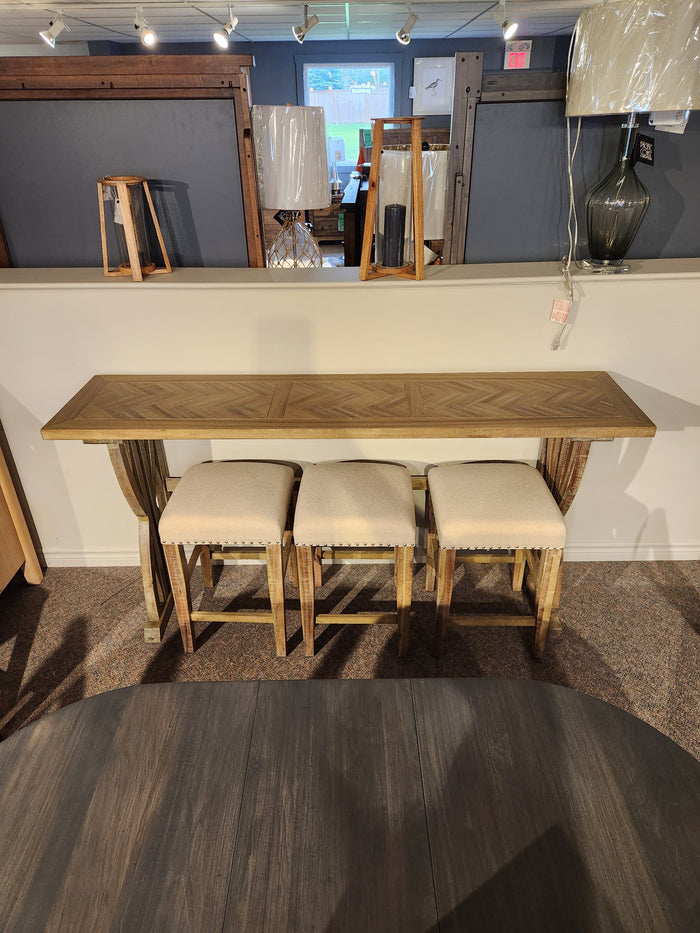 The Jofran 1933-74 Fairview Counter Table with 3 stools features a chevron top and linen-blend seats in a showroom.