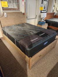 A wooden bed frame with storage drawers and a Beauty-rest Mira TT Medium Mattress with pocket coil system.