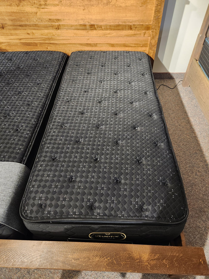A Beauty-rest Apollo PT Medium Mattress rests on a wooden bed frame in a carpeted room.