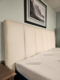 The Palliser 77140 Verttia King Upholstered Bed pairs with a mattress and framed landscape, with customizable options.
