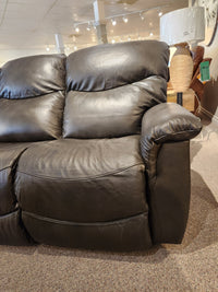 The La-z-boy 521 James Power Sofa, a dark brown recliner with plush cushions, sits on a carpeted showroom floor.